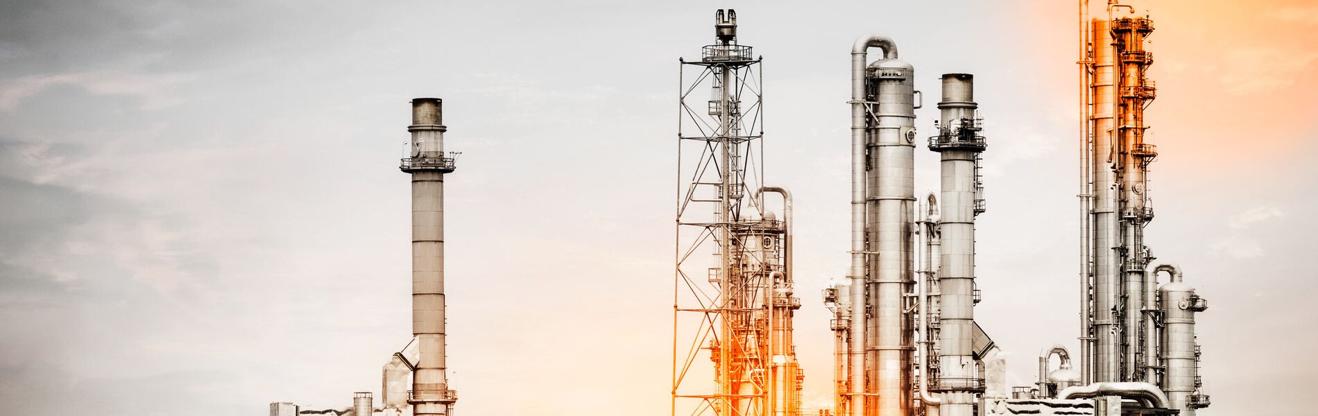 Offshore oil and gas industry with piping and valves, worker in foreground