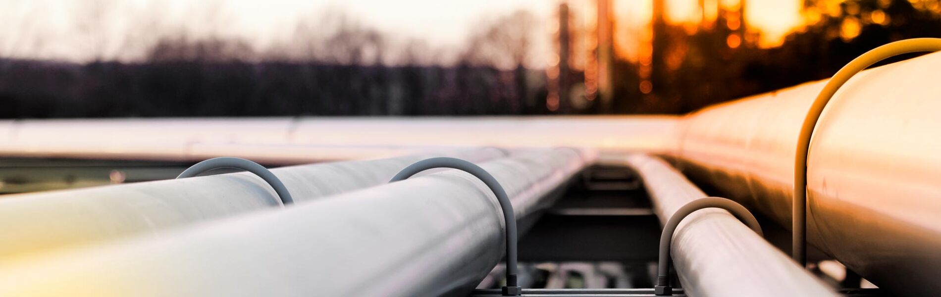 Offshore oil and gas industry with piping and valves, worker in foreground